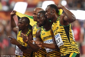Usain Bolt, right, with other team mates after sweeping the 100 metres gold