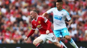 Wayne Rooney escapes from a Newcastle player