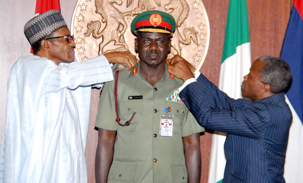 Buratai, middle being decorated by President Buhari, left and VP Osinbajo recently