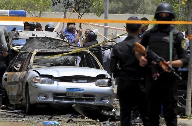 File photo: Policemen secure the site of a car bomb attack