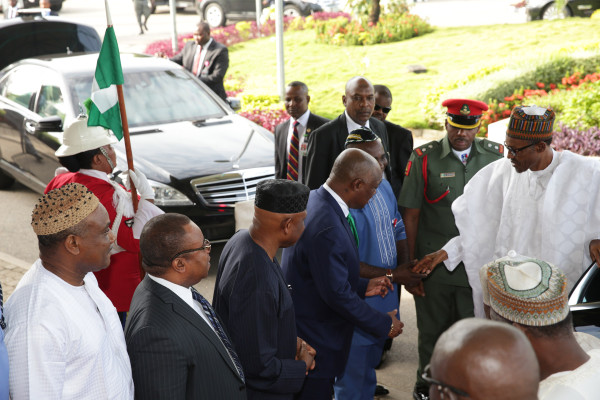 President Muhammadu Buhari in a hand shake with his Special Assistant on National Assembly matters, Senator Ita Enang, FCT Permanent Secretary, Chief John Chukwu and others PHOTO; SUNDAY AGHAEZE.