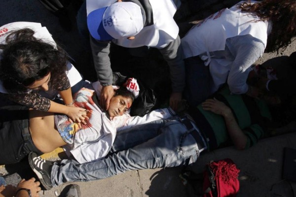 Rescue workers attend to an injured victim. AFP Photo