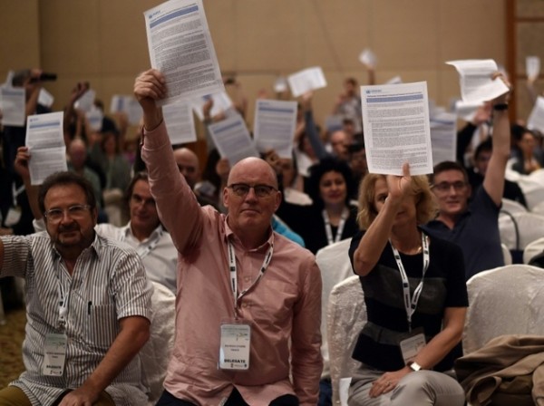 Delegates hold copies of the UN document urging for the decriminalisation of hard drugs