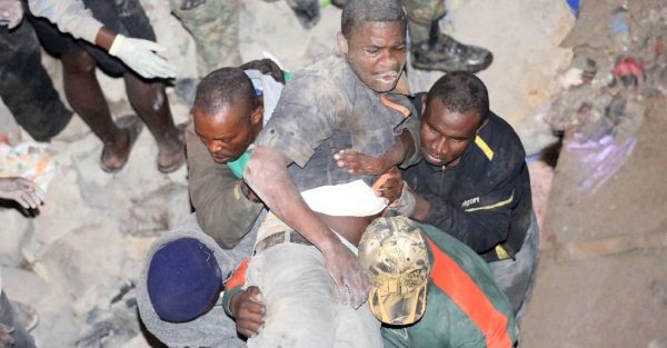 a man being pulled out of the collapsed building