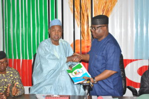 National Organising Secretary of the All Progressives Congress (APC), Senator Osita Izunaso (left) handing over relevant documents for the 2016 Edo State governorship election primaries to the Chairman of the Election Committee, Katsina State Governor, Aminu Bello Masari at the Party’s National Secretariat on Thursday.