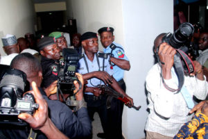 Police officers threaten to shoot journalists as they struggle to control crowd in the court premises (photo: Femi Ipaye)