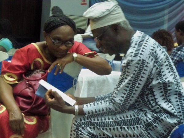 Prof. Adenike Osofisan showing her husband's book another guest