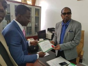 Ogah, receiving his certificate of return