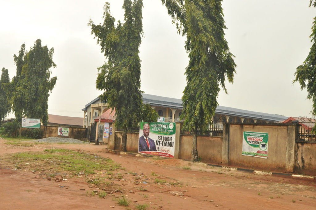 Campaign banner of the PDP candidate, "Pastor" Osagie Ize-Iyamu at the entrance of the Church gate.