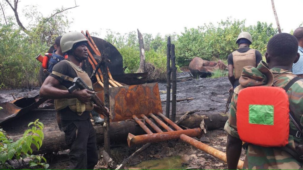 Naval personnel at the scene of one of the illegal refineries