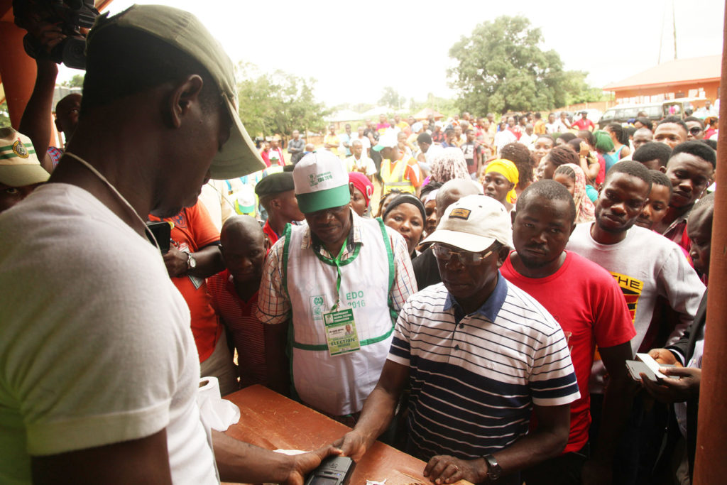Governor Adams Oshiomhole's thumb being captured by a card reader at Ward 10, Unit 1, Iyamho to cast his vote in the Edo governorship election, on Wednesday.