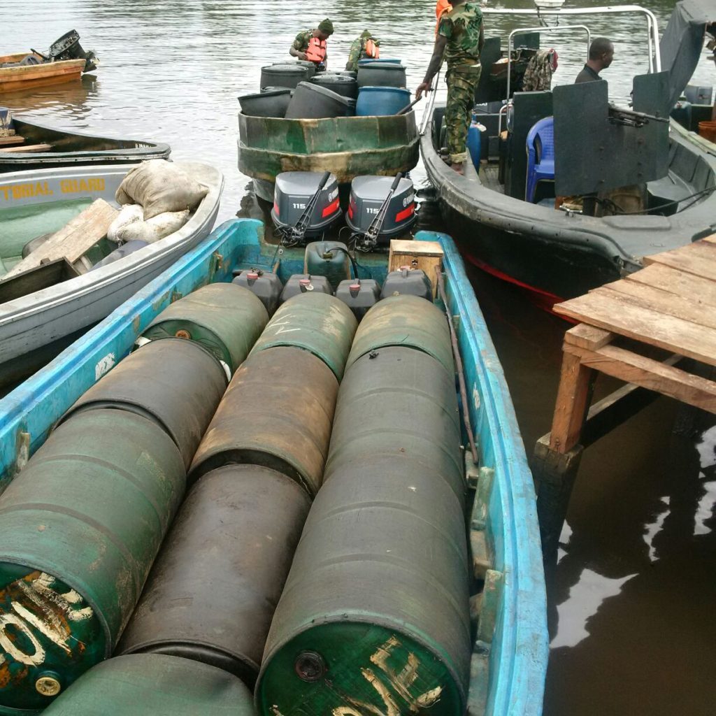 Outboard engines and drum for illegally refined oil seized by the troops
