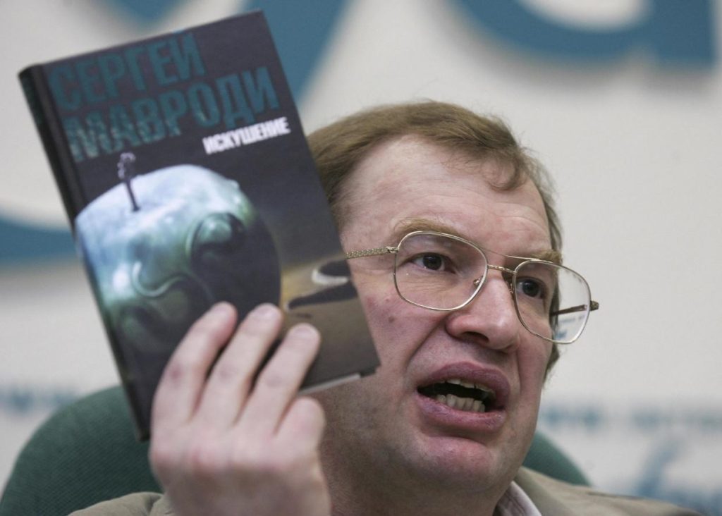 The founder of the MMM financial pyramid scheme Sergey Mavrodi, holding a copy of his banned book ‘Temptation’ in Moscow in May 2008. Mavrodi’s schemes stole life savings from more than a million Russians in the early 1990s AFP/Getty