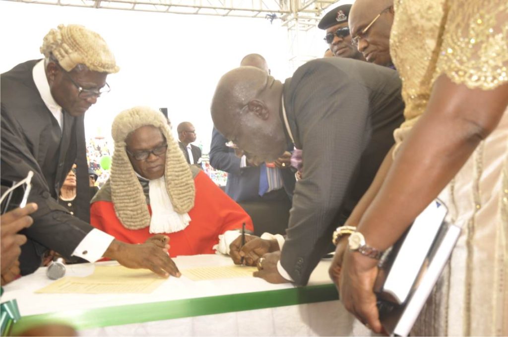 Obaseki signs the register after taking oath of office