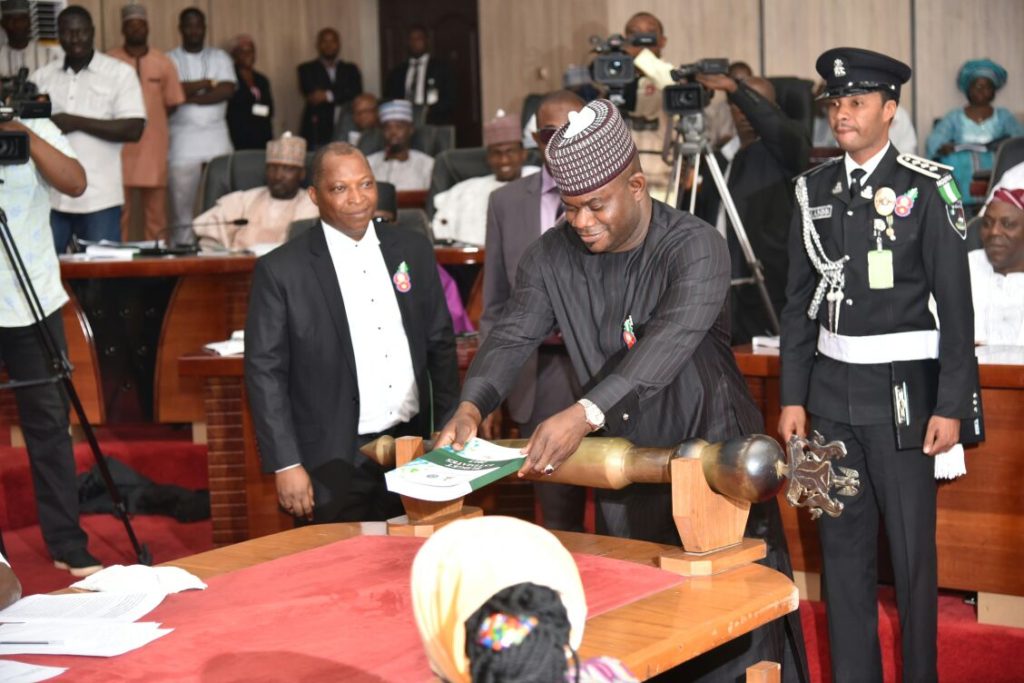Governor Yahaya Bello lay the budget document on the table after presenting it to Kogi House of Assembly