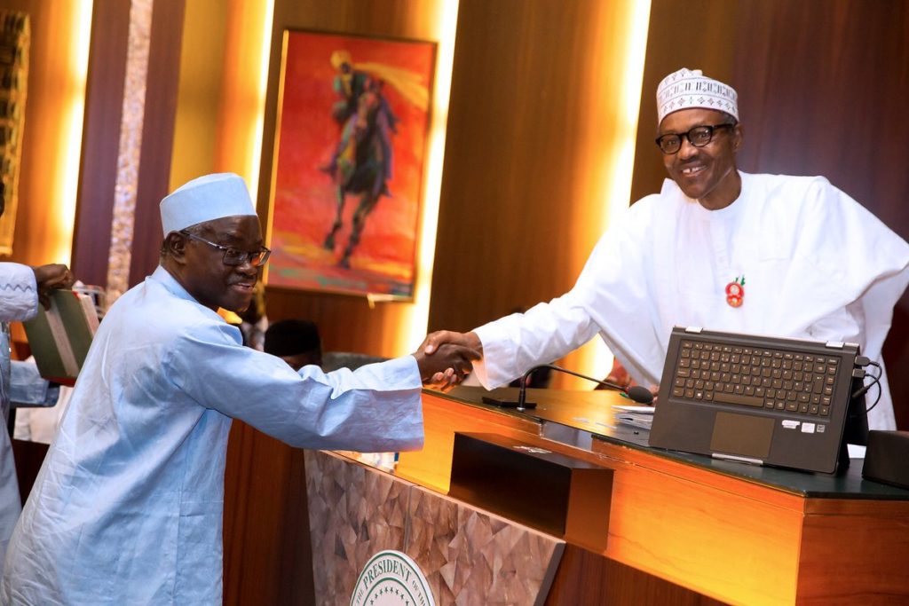 President Buhari shakes Mohammed Kudu Haruna, one of the new INEC Commissioners