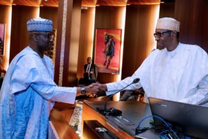 President Buhari, right, shakes Boss Mustapha