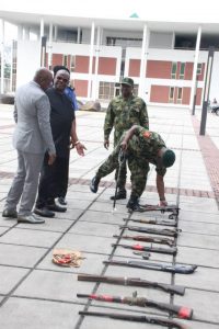 Pictures 1 and 2: Rivers State Governor, Nyesom Ezenwo Wike (2nd L) and Service Commanders during the submission of Arms surrendered by repentant criminals at the Government House Port Harcourt on Tuesday