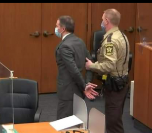 A cop leading off Chauvin after he was found guilty on all the four counts of murder