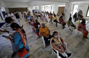 People sit in a waiting area to receive a dose of COVISHIELD, a coronavirus disease (COVID-19) vaccine manufactured by Serum Institute of India, at a vaccination centre in Ahmedabad, India, April 2, 2021.