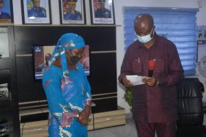 The Secretary to the State Government, Dr. Tammy Wenike Danagogo handing over cheques to one of the widows.