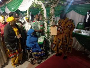 Governor Ganduje presenting a letter of permanent and pensionable appointment to Khadijah Umar who lost her legs in the course of her service to Kano state