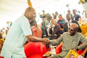 File: Ize-Iyamu greeting Gov. Obaseki at a function