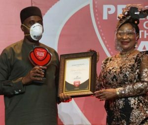 Rt. Hon Chibuike Rotimi Amaechi, Minister of Transportation receiving the award from former Minister of Industry, Nike Akande