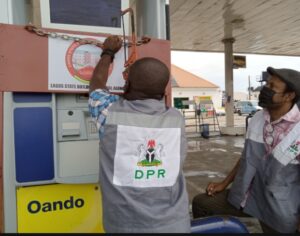 DPR officials unsealing a filling station sealed by the Lagos State Building Control Agency on Thursday in Lagos