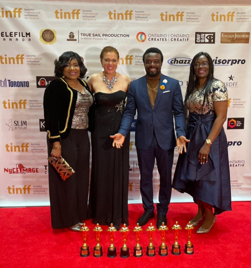Austin Odigie ( second from right) and other members of Empathy movie crew with the award won by the movie