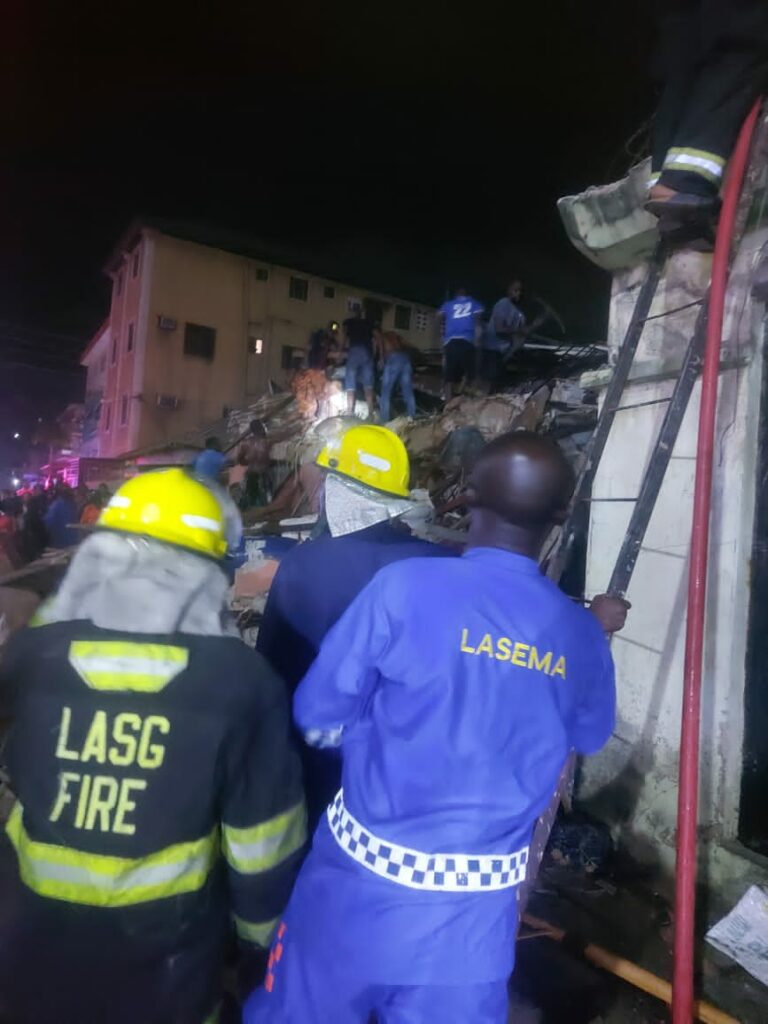 Rescue workers at the site of the collapsed building in Ebute Meta, Lagos