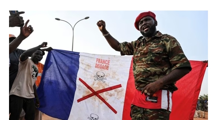 Supporters of Niger’s National Council of Safeguard of the Homeland (CNSP) display a French national flag with a x-mark on during a protest outside Niger and French airbase in Niamey on September 1, 2023 to demand the departure of the French army from Niger. (Photo by – / AFP)