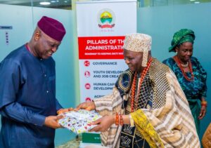 The Elemure of Emure Ekiti, Oba Emmanuel Adebayo, presenting a gift to the Ekiti State Governor, Biodun Oyebanji, during a courtesy visit to the Governor in Ado Ekiti
