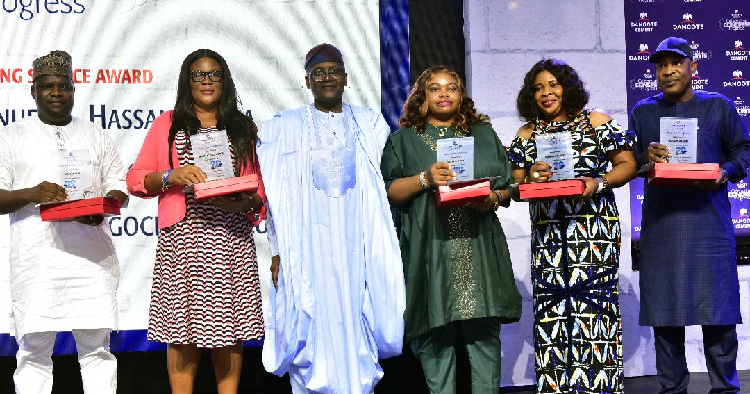 L -R, Group Managing Director, Dangote Industries Limited, Olakunle Alake, 20 years Meritorious and Dedication Service to Dangote Cement plc, Ngwu Ugochukwu Lucy, Chairman Dangote Cement plc, Aliko Dangote, Ukamaka Emmanuel, 20 years Meritorious and Dedication Service to Dangote Cement plc, at the Dangote Cement plc Long Service Awards in Lagos on Friday 8th December 2023