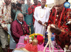 The Representative of Abia State on the NDDC Governing Board, Chief Eruba Dimgba (sitting), receiving a chieftaincy title from the Chairman of Ukwa West Traditional Rulers Council, Eze Chinyere Dike during a reception organised in his honour by the people of Asa community at the Ogwe Central School, Asa.