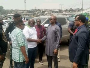 Dr Tammy Danagogo Secretary to Rivers State Government SSG,in handshake with State Chairman Maritime Workers Union (white T-shirt)Comrade Israel Waribo Pepple at the scene of fire disaster at Nembe-Bille-Bonny Jetty