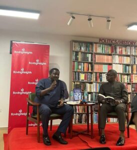 Femi Adesina, left, speaking about his book