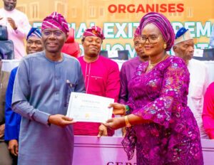Governor of Lagos State, Mr. Babajide Sanwo-Olu presenting a certificate of completion to a mortgagor, Mrs. Pitan Oludayo Modupe during the inaugural exit ceremony for LAGOS HOMS Mortgagors at the NECA House, CBD-Alausa, Ikeja, on Thursday, 29 August 2024
