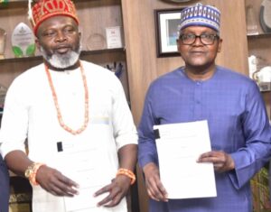 L-R: Managing Director, Nigeria Gas Marketing Limited (NGML), Barr. Justin Ezeala and President/CEO of the Dangote Group, Aliko Dangote display a signed Gas Sale and Purchase Agreement (GSPA) for the supply of natural gas to the Dangote Petroleum Refinery and Petrochemicals FZE, on Tuesday, in Abuja.