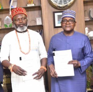 L-R: Managing Director, Nigeria Gas Marketing Limited (NGML), Barr. Justin Ezeala and President/CEO of the Dangote Group, Aliko Dangote display a signed Gas Sale and Purchase Agreement (GSPA) for the supply of natural gas to the Dangote Petroleum Refinery and Petrochemicals FZE, on Tuesday, in Abuja.
