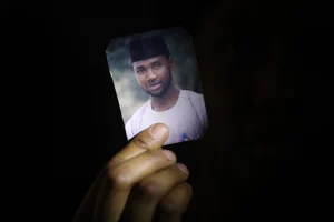 Amina Ahmed, wife of Mubarak Bala, an outspoken atheist who was charged with blasphemy, displays her husband's photo at their home in Abuja, Nigeria on March 11, 2021. Kola Sulaimon/AFP via Getty Images
