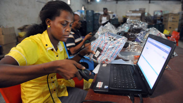 A Jumia worker scans a product at a warehouse in Lagos. Credit:AFP