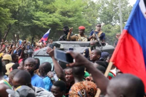 Burkina Faso's self-declared leader Ibrahim Traoré is welcomed by supporters holding Russian flags as he arrives at the national television station in Ouagadougou, Burkina Faso on October 2, 2022. Vincent Bado/REUTERS