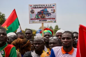 A person holds a sign with a picture of Captain Ibrahim Traoré while attending a rally by supporters of Burkina Faso's junta to mark the one-year anniversary of the coup that brought Traoré to power in Ouagadougou, Burkina Faso, on September 29, 2023. Yempabou Ouoba/REUTERS