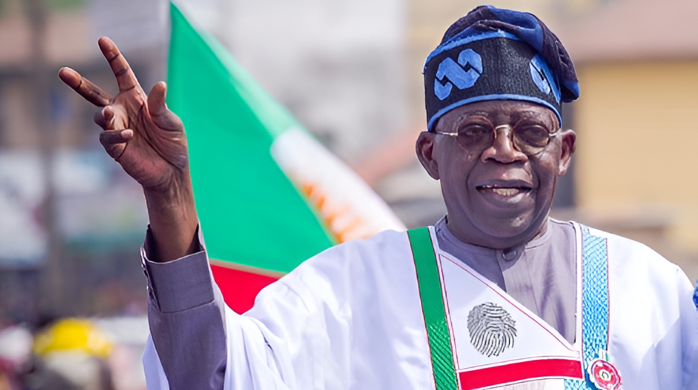 File. President Tinubu making victory sign