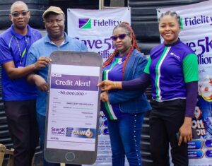 L – R: Direct Sales Executive, Fidelity Bank Plc, Adegboyega Ademokunwa; GAIM 6 Eight Monthly draw Winner, Innocent Okoro Orji; Branch Leader, Fidelity Bank Plc, Gbagada, Chinwe Umez-Eronini; and Product Manager, Savings, Fidelity Bank Plc, at the GAIM 6 prize presentation ceremony held at Gbagada Building Materials market in Lagos recently