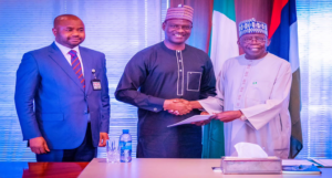 From right, President Bola Ahmed Tinubu, Mr.Taiwo Oyedele, Chairman of the Presidential Committee on Fiscal Policy and Tax Reforms, Submitting the Committee's Report to the President, with Mr. Zacch , FIRS Executive Chairman of FIRS, in the State House Recent