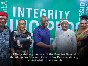 Professor Nnaji shaking hands with Emeana