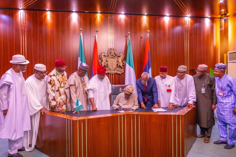 President Tinubu signing the electoral bill